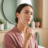Woman dermaplaning her face with GlowPro Dermaplane Razor