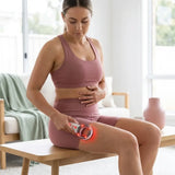 Woman using 3-in-1 slimming massager on bare thigh